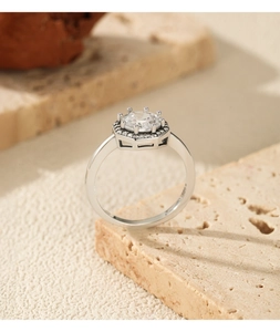 Macro detail of S925 silver ring featuring an octagonal halo setting with a round gemstone