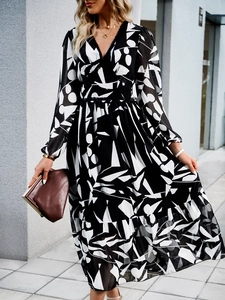 Detail of V-neck long sleeve dress with black and white geometric print and waist tie