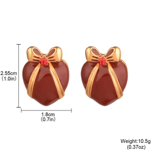 Vintage red heart earrings with golden edges and bow details on white background