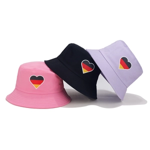 Three cotton bucket hats in pink, black, and purple with German flag heart embroidery