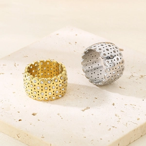 Close-up of gold and silver geometric hollow titanium steel rings with diamond inlay