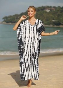 Detail view of a V-neck knit snake print beach cover-up robe at sunset scenery