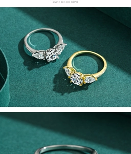 Macro detail of silver and gold rings with round and pear-cut cubic zirconia stones