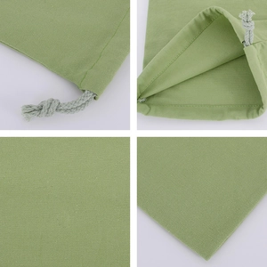 Macro details of green cotton canvas drawstring bag showing fabric texture and stitching