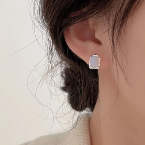 Elegant 925 sterling silver stud earrings with light blue square gemstone on model