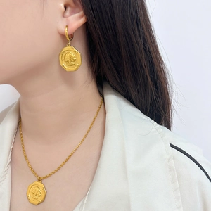18K gold plated stainless steel octagon embossed necklace and earrings set worn by a model