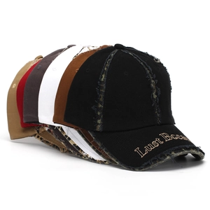Detail of baseball caps with 3D letter embroidery and vintage distressed frayed edges