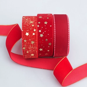 Red velvet Christmas ribbons set with gold glitter and stars for festive gift wrapping