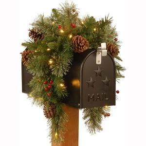 Christmas pine cone mailbox wreath with warm LED lights and red berries on black metal