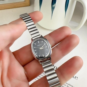 Close-up of a silver alloy oval watch featuring a black dial with bar markers and NAIDU logo