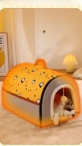 Detail of semi-enclosed warm cat house with orange cat print and hanging toy ball