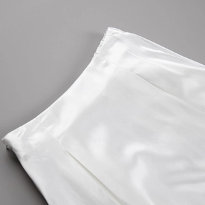 Detailed view of white satin skirt waist with invisible zipper and elastic back band