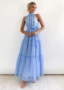 Detail of light blue plaid halter maxi dress featuring layered tiered skirt and waist belt