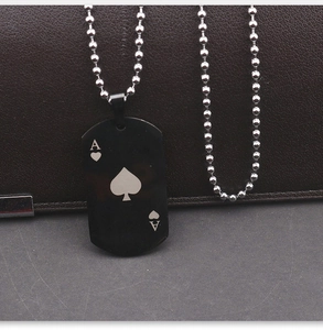 Detail of laser-engraved Ace of Spades on black stainless steel pendant with bead chain