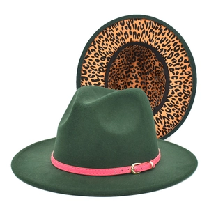 Detail view of dark green fedora hat featuring leopard print lining and pink buckled strap