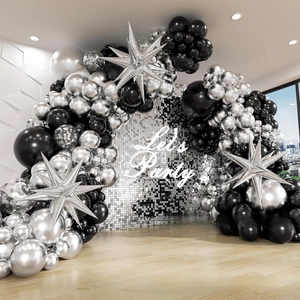 Close-up of black and silver balloon arch kit with metallic star foil balloons for parties