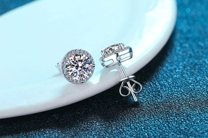Macro shot of silver round halo stud earrings with brilliant cut moissanite stones