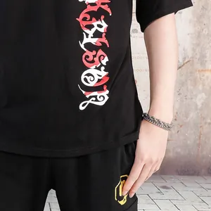 Close-up of double-layer stainless steel keel chain bracelet on model wrist with streetwear