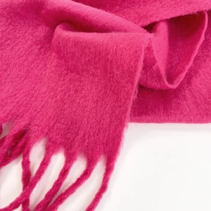 Detailed close-up of rose red mohair scarf showcasing soft fuzzy texture and fringed edges