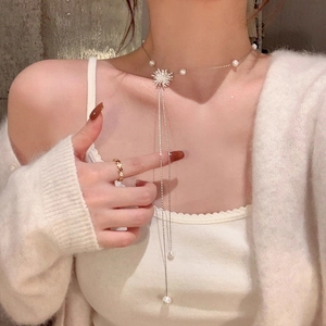 Ensemble élégant de collier choker en perles étoiles zircon et bague dorée sur modèle