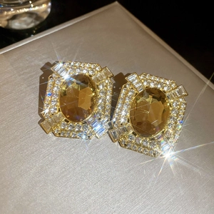 Macro shot of vintage square earrings with champagne crystal and glittering zircons