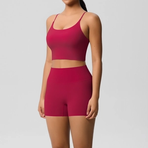 Detail of red yoga set showing high-waist shorts and strap crop top fit