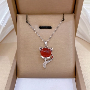 Luxurious fox pendant necklace with red gemstone and pavé diamonds on silver chain