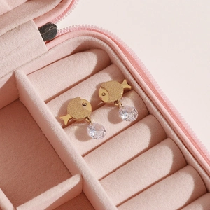 Golden fish stud earrings with sparkling round cubic zirconia in a pink jewelry box