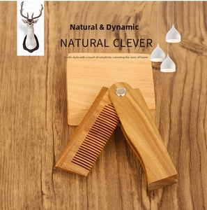 Macro detail of natural sandalwood folding comb with uniform teeth and rotating metal hinge