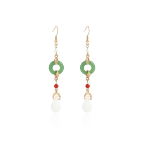 Detail of Chinese style tassel earrings with green jade-like hoop and pearl drop charms