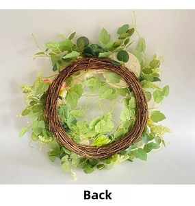 Detailed back view of a 2025 artificial wreath with brown vine base and green foliage
