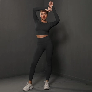 Detail of black seamless scrunch leggings and long sleeve crop top gym set