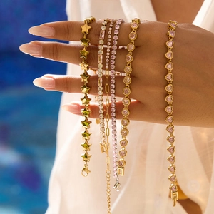 Classic 18K gold and silver stainless steel star bracelets shown on a model's wrist