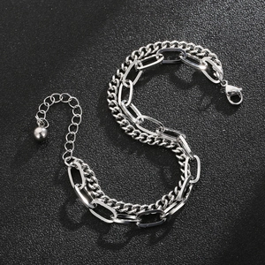 Close-up of a double-layered silver chain bracelet with Cuban and paperclip links