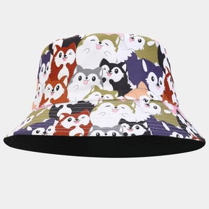 Detail of a reversible bucket hat featuring colorful cartoon husky dog prints all over