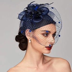 Close-up of navy blue bridal fascinator hat with elegant feather flower and dotted mesh veil
