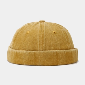 Detail view of mustard yellow vintage miki hat showing washed cotton texture and stitching