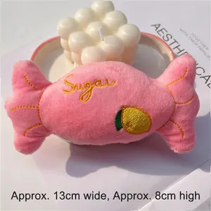 Detailed close-up of a pink plush candy pet toy with Sugar embroidery and dimensions