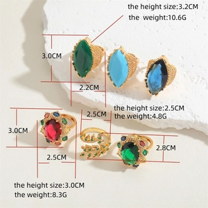 Luxurious gold rings set with colorful marquise and oval zircon stones on white stone