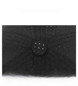 Detailed top view of breathable mesh fabric and reinforced stitching on a black sun hat