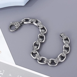 Macro detail of vintage silver steel chain with spiral engraved links and lobster clasp