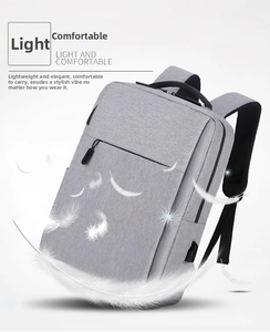 Detail of grey business laptop backpack with USB port and lightweight textured fabric