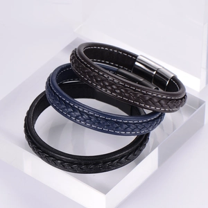 Detail of woven leather bracelets in black, blue and brown with magnetic metal clasps with magnetic steel closure