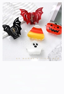 Close-up of Halloween acrylic hair clips featuring ghost, pumpkin, and bat designs