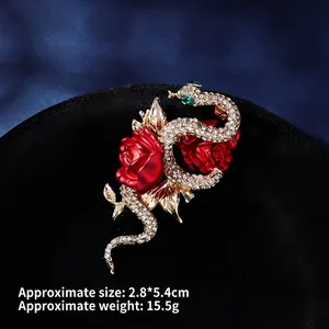 Detail view of a vintage snake and red rose brooch with crystals, size 2.8x5.4cm