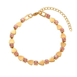 Detail of gold chain bracelet featuring pink rhinestones and heart charms on white background