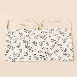 Detail of soft cotton muslin texture and vintage floral botanical print on the waist apron