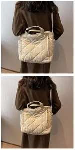 Detailed view of cream quilted tote bag showing rhombus stitching and side pockets