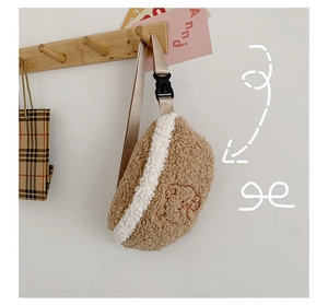 Detail of plush lamb wool waist bag featuring a brown teddy bear embroidery and strap