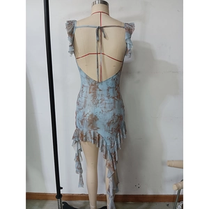 Detail of cross-tie backless design and asymmetric ruffled hem on tie-dye dress